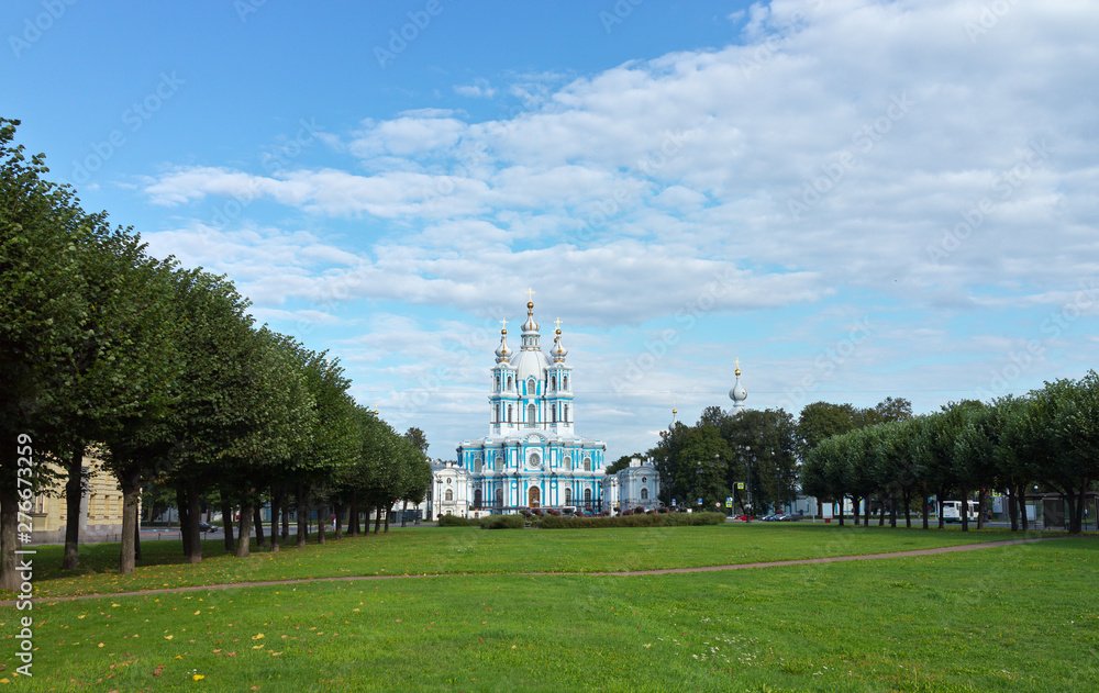 Saint Petersburg in the summer. View from the city park with green lawns on the Smolny Cathedral on a sunny day. Beautiful cityscape