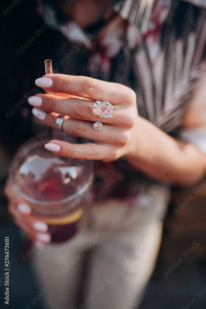 woman holding a fruit cocktail in her hand woman holding a fruit cocktail in her hand