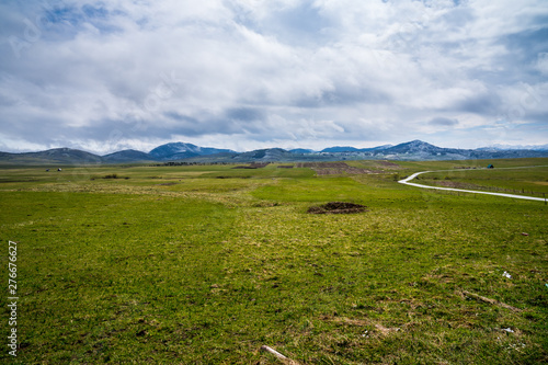 Montenegro, Endless green pastures and mountains forming highlands nature landscape near provalija town photo