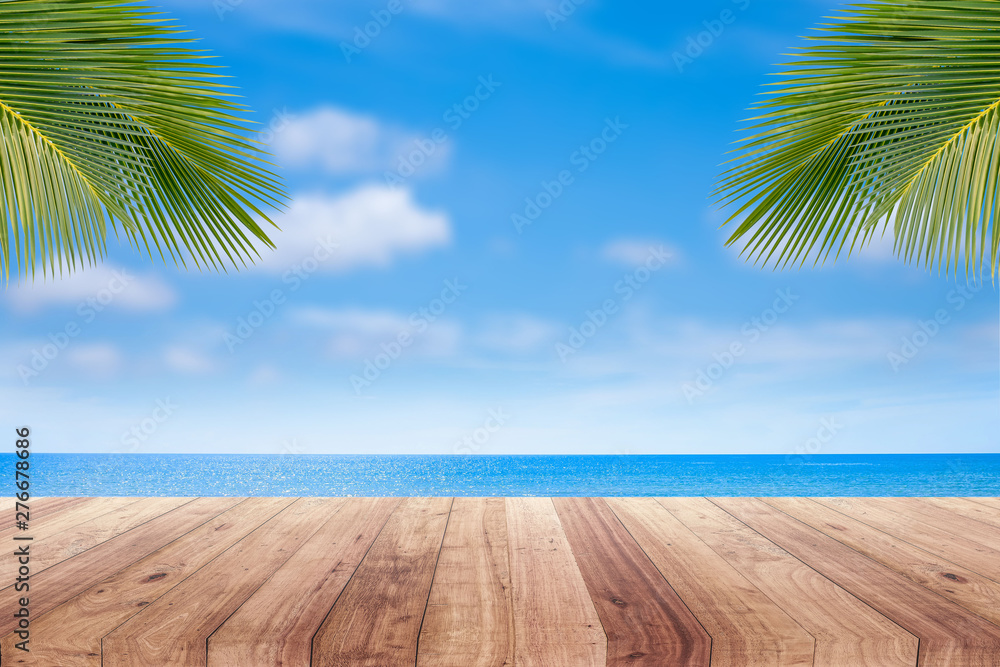 wooden table top on blurred beach background for product display.