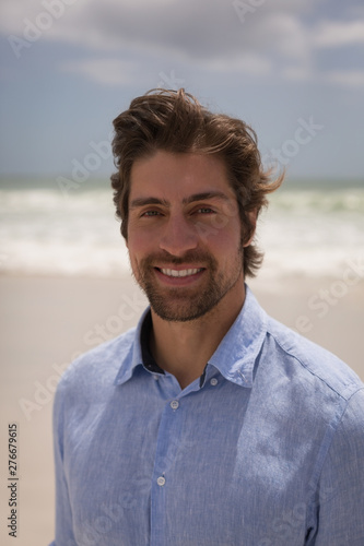 Happy man standing on the beach