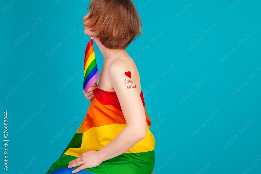 young woman covering with lgbt pride flag young woman covering with lgbt pride flag