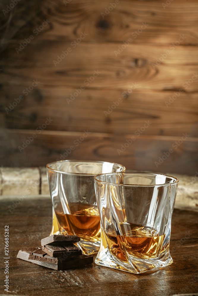 Two glasses of bourbon or scotch, or brandy and pieces of dark chocolate Two glasses of bourbon or scotch, or brandy and pieces of dark chocolate