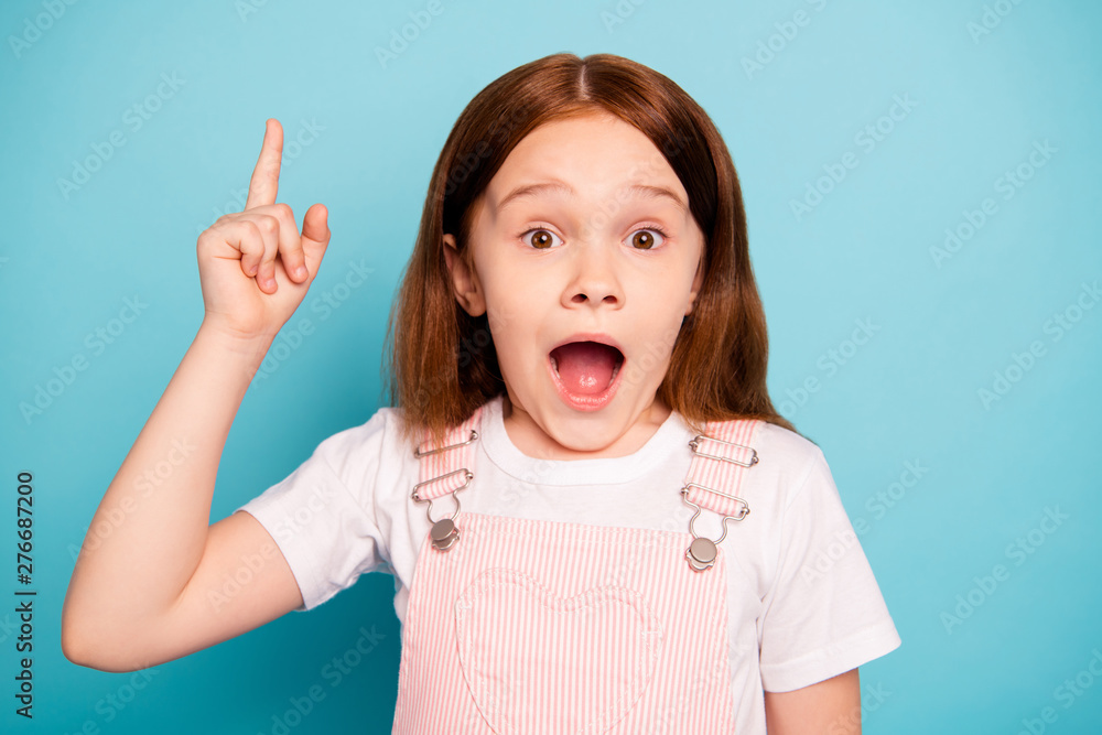 Close up photo of cute stylish kid raise index finger show scream shout isolated blue background Close up photo of cute stylish kid raise index finger show scream shout isolated blue background