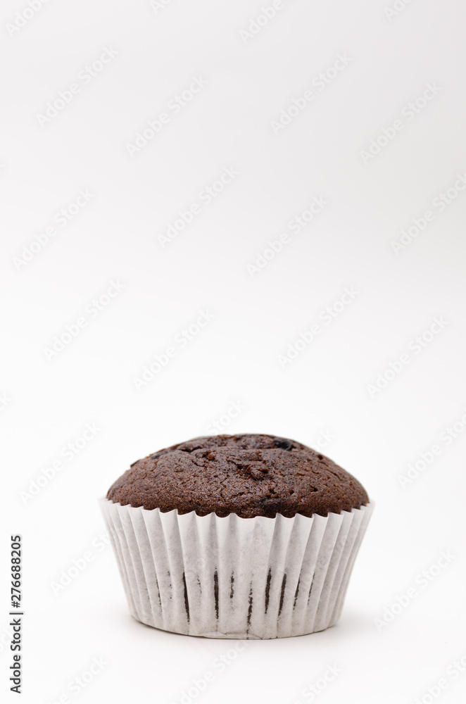 Chocolate cake in a paper cup on a white background Chocolate cake in a paper cup on a white background