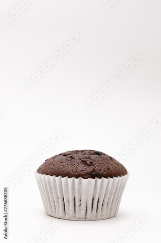 Chocolate cake in a paper cup on a white background