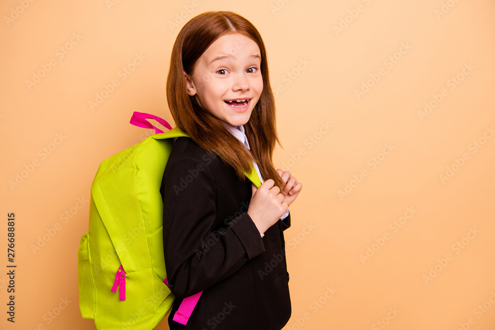 Close-up profile side view portrait of nice attractive lovely cheery cheerful confident positive pre-teen girl learner wearing formal jacket blazer back to school isolated over beige pastel background Close-up profile side view portrait of nice attractive lovely cheery cheerful confident positive pre-teen girl learner wearing formal jacket blazer back to school isolated over beige pastel background
