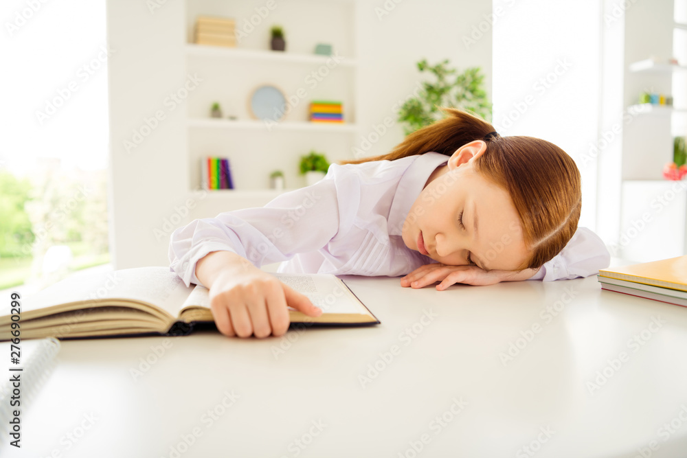 Portrait of sad upset kid little person lie desk close eyes touch printed book sit interior class white blouse shirt foxy ginger hairstyle hairdo tails pigtails ponytails Portrait of sad upset kid little person lie desk close eyes touch printed book sit interior class white blouse shirt foxy ginger hairstyle hairdo tails pigtails ponytails