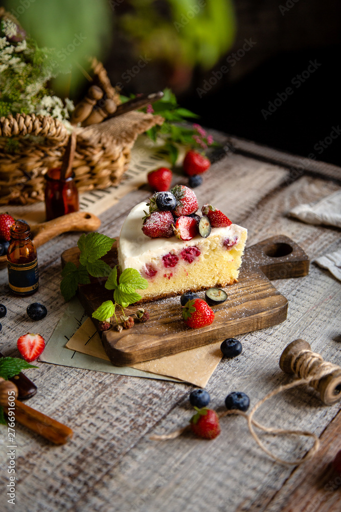 Homemade delicious slice of raspberry biscuit cake with white cream, strawberries, blueberries Homemade delicious slice of raspberry biscuit cake with white cream, strawberries, blueberries