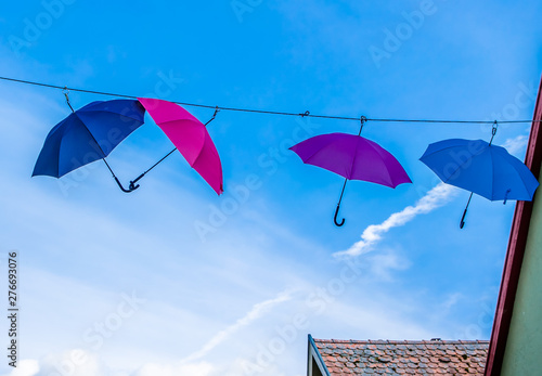 two umbrellas blue and pink together