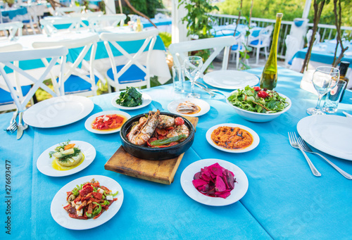 Shrimp  Seafoods  appetizers and salads on the table in Fish Restaurant. Beach Restaurant in Greece or Turkey. Aegean seaside  Greek or Turkish style fish restaurant in Bodrum  Santorini or Mykonos