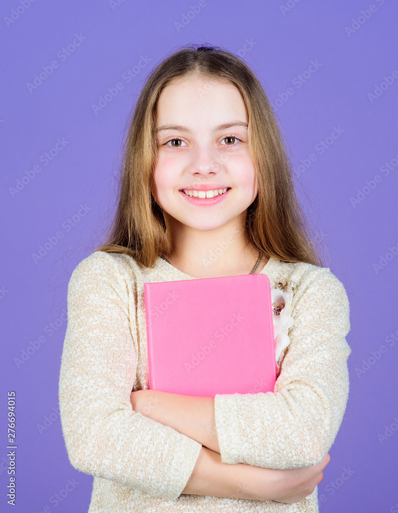 Notepad planner. Learn more. Girl hold book violet background. Kid show book notepad. Book concept. Wise quotes. Childhood literature. Development and education. Reading skill. Personal diary Notepad planner. Learn more. Girl hold book violet background. Kid show book notepad. Book concept. Wise quotes. Childhood literature. Development and education. Reading skill. Personal diary