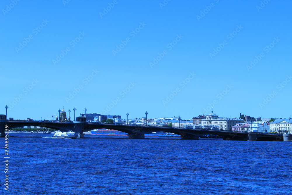 Bridge across the Neva River. Saint-Petersburg. Under the bridge floats boat 