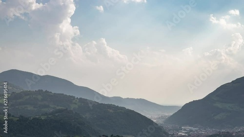 Storm clouds rolling in the sky during rain storm in time lapse in Valle Seriana, Bergamo, italy photo