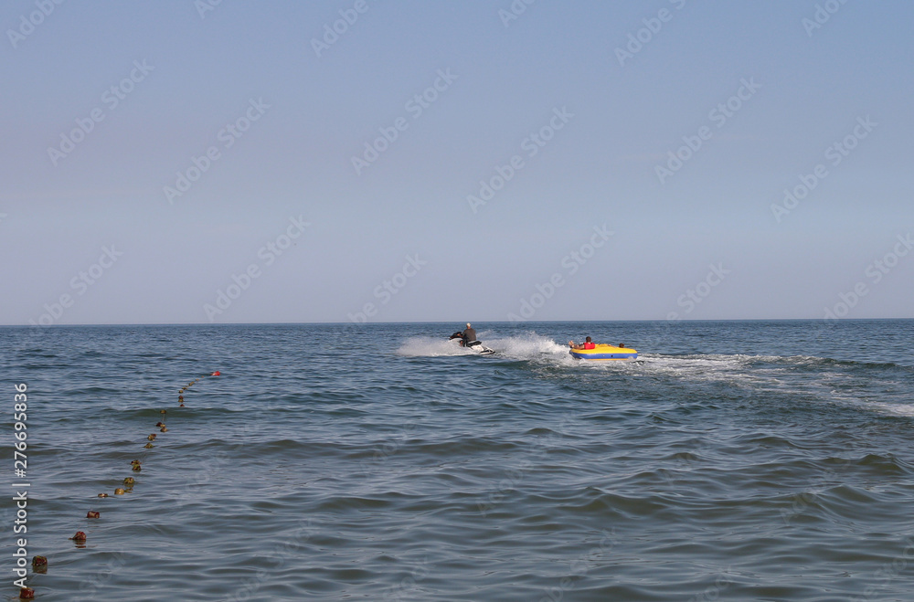people relax on the sea and ride a water water inflatable tablet people relax on the sea and ride a water water inflatable tablet