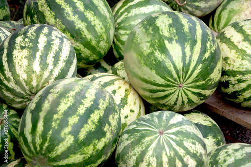 many watermelons are sold on the street in the summer in the heat