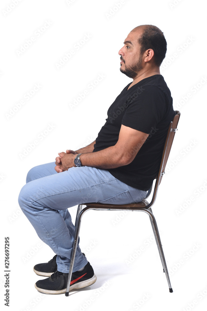 full portrait of a south american  man sitting on a chair on white