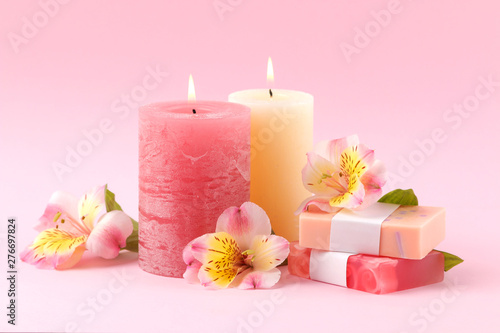 Spa. Aromatherapy. Body care cosmetics. Handmade soap and candles on a gentle pink background