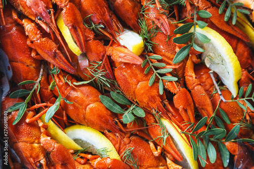 Close-up of boiled crawfish with lemon and herbs