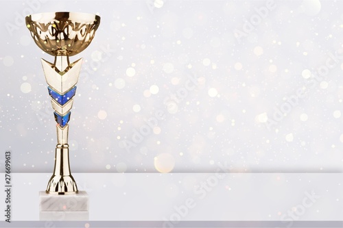 Valokuva Gold Cup stands on a white table
