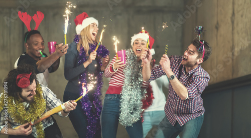 multiethnic group of casual business people dancing with sparklers