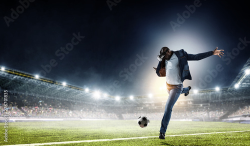 Virtual Reality headset on a black male playing soccer. Mixed media