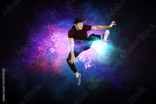 Modern dancer jumping with colourful splashes background. Mixed media © Sergey Nivens