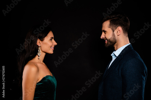 Close up side profile photo pair she her classy he him his macho tenderness look face-to-face sincere glad meeting wear plaid blue costume jacket green glossy velvet dress isolated black background