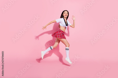 Profile side full length body size view of her she nice-looking attractive lovely graceful slender slim cheerful cheery glad straight-haired lady running fast isolated over pink pastel background