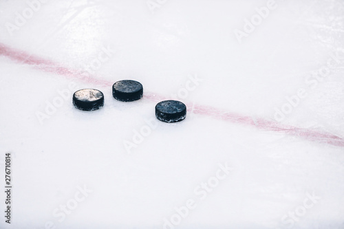 Hockey pucks on ice
