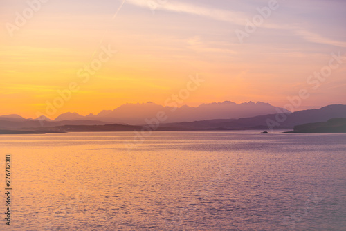 Isle of Skye Sunrise - golden sun glow on ocean, mountains and islands
