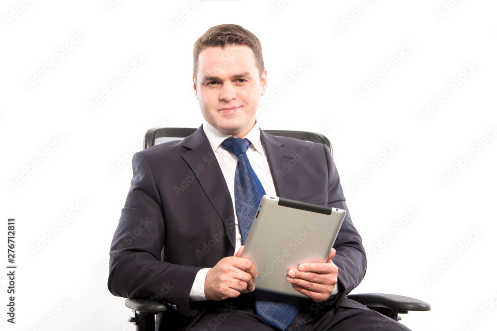 Smiling businessman with tablet in hands sitting in his chair. Smiling businessman with tablet in hands sitting in his chair.