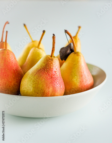 ripe yellow pears with drops in a plate