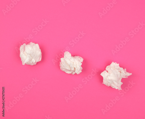 Fototapeta Naklejka Na Ścianę i Meble -  three crumpled white paper napkins on a pink background
