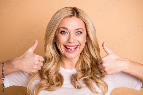 Close up photo amazing beautiful she her lady perfect ideal appearance hold arms hands thumbs raised up advising buy buyer customer product wear casual white t-shirt isolated beige pastel background