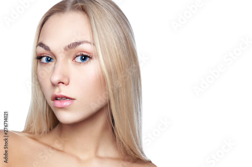 Portrait of young beautiful girl with long blond hair and natural make-up