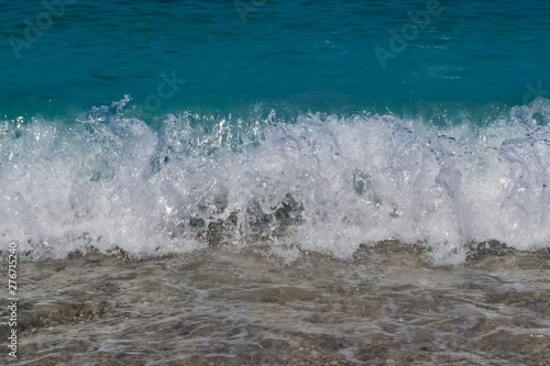 Sea water waves foam lapping to coastal shore © Aleksandr