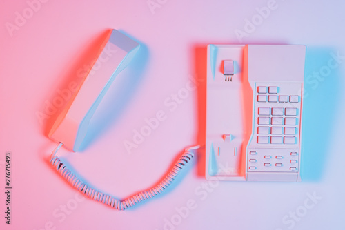 High angle view of pink retro landline telephone with receiver