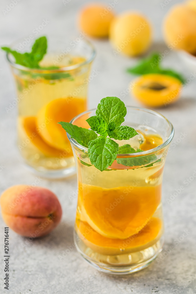 Summer drink, apricot mint tea. Selective focus, space for text. Summer drink, apricot mint tea. Selective focus, space for text.