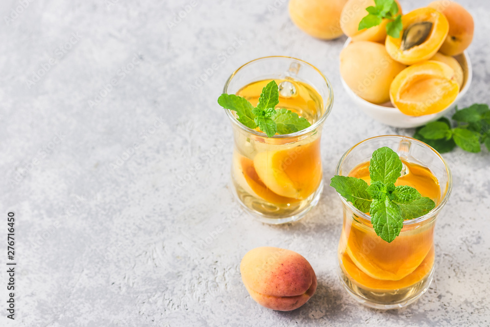 Apricot mint green tea. Selective focus, space for text. Apricot mint green tea. Selective focus, space for text.