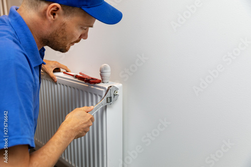 house heating system installation plumber installing radiator