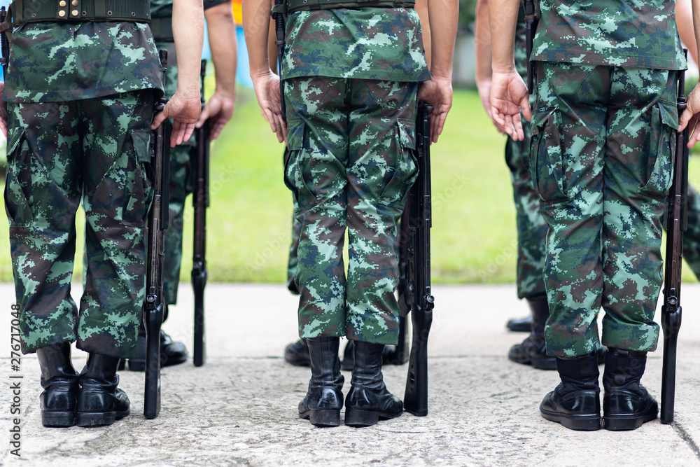 The Army soldier stand in row they are wear hat and wear Military vest The Army soldier stand in row they are wear hat and wear Military vest