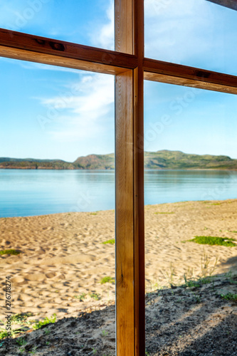 Beautiful sea view from the window. Clear sunny day. Close-up. Vertical.