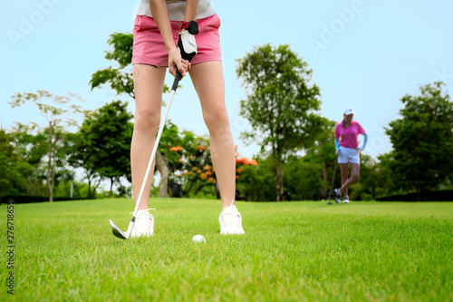 Pitching being hit or chip to a golf ball by woman golfer, to reach the final best score winning, chip golf ball from rough of fairway to the hole on the green
