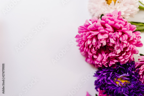 Flowers composition. Violet and purple flowers on white background. Frame made of flowers. Valentines day, mothers day, womens day, spring, summer concept. Flat lay, top view, copy space.