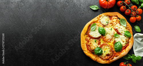 Homemade pizza with mozzarella on dark background