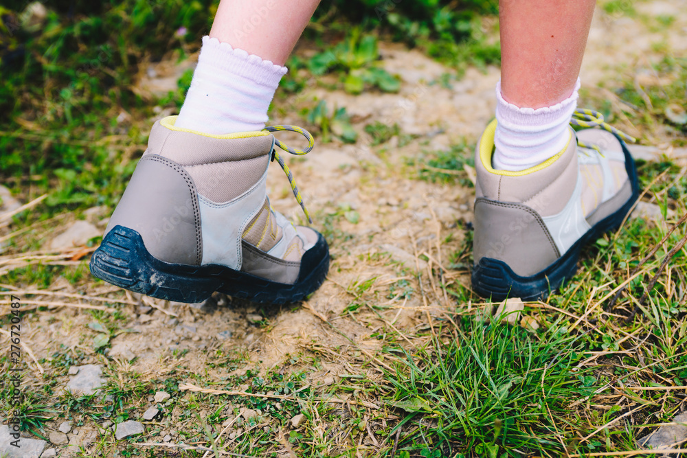 Closeup of trekking shoes of a young mountain tourist