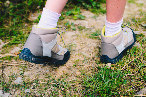Closeup of trekking shoes of a young mountain tourist