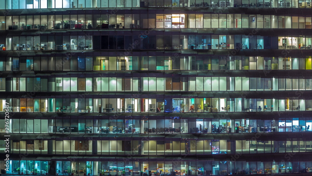 Working evening in glass office building with numerous offices with glass walls and windows timelapse Working evening in glass office building with numerous offices with glass walls and windows timelapse