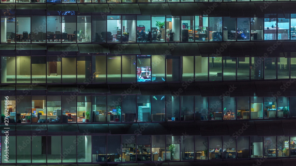 Working evening in glass office building with numerous offices with glass walls and windows timelapse Working evening in glass office building with numerous offices with glass walls and windows timelapse
